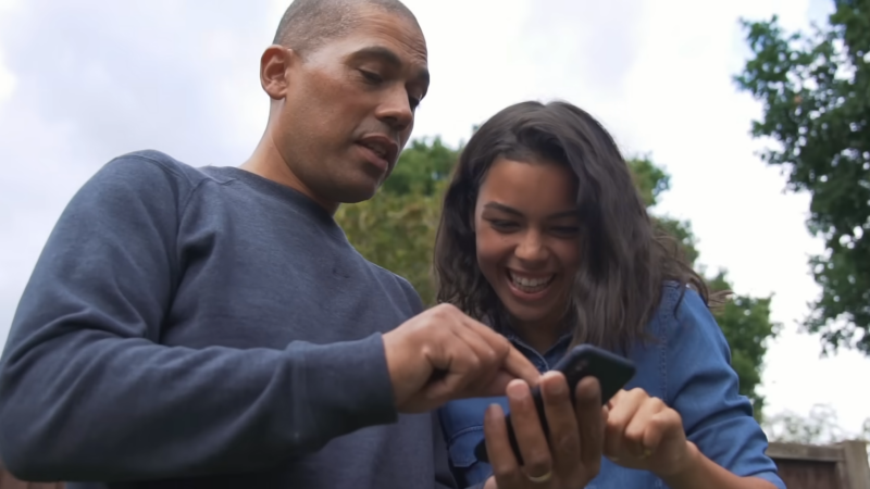 Father and Daughter Using an App for Teen Banking