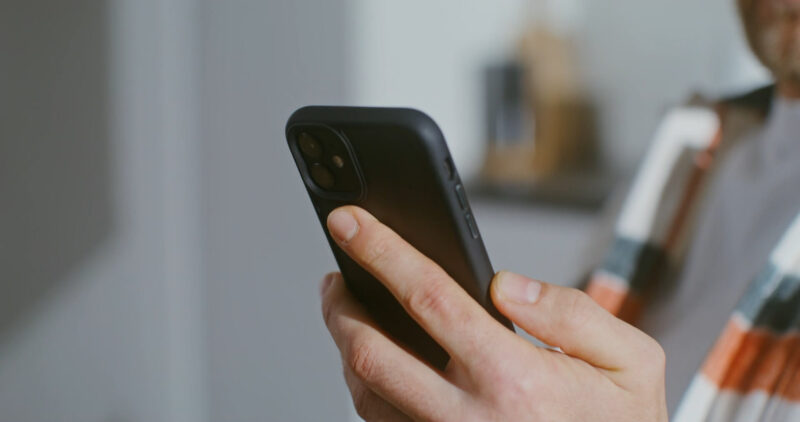 A guy with the mobile phone in the hands