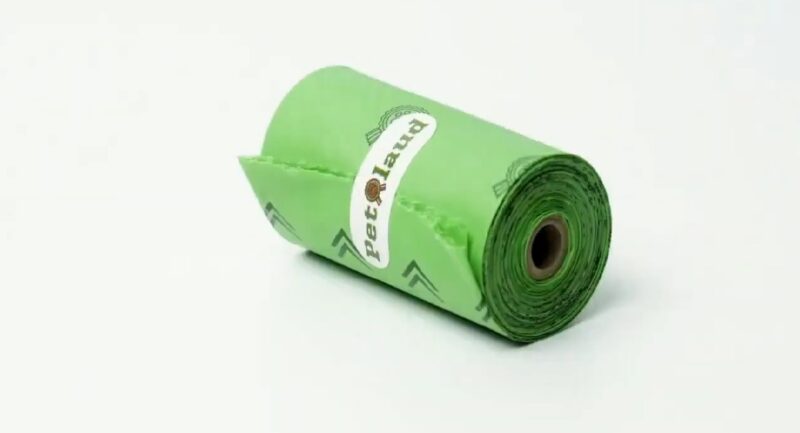 A roll of green biodegradable dog poop bags labeled PetLaud